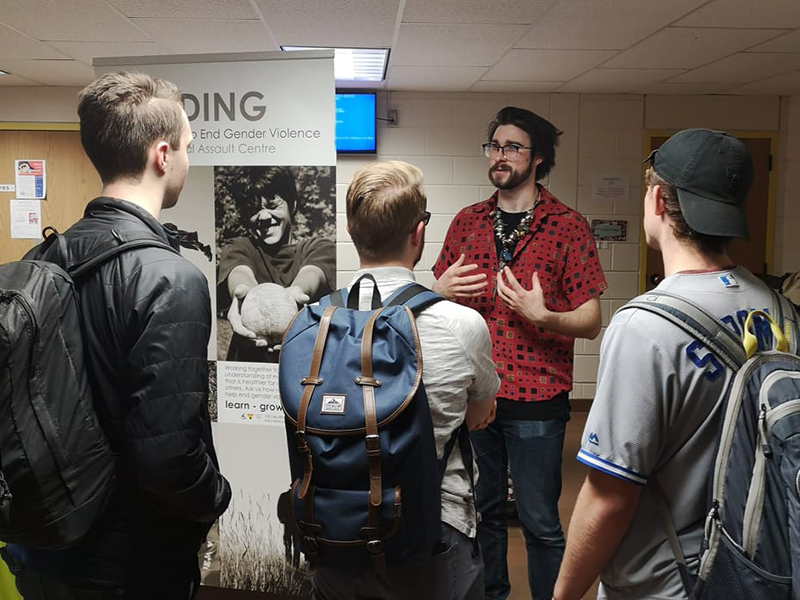 group of students gather to learn about the MENding program